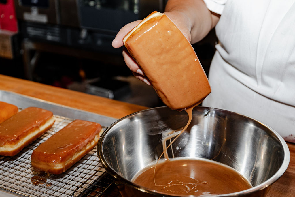 Glazing a filled dona by hand