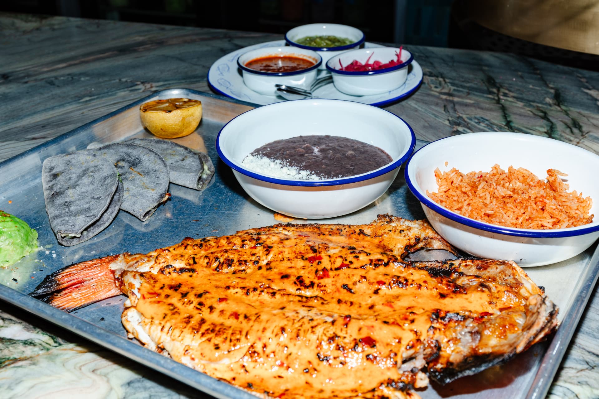 Whole grilled branzino with rice, beans and salsas