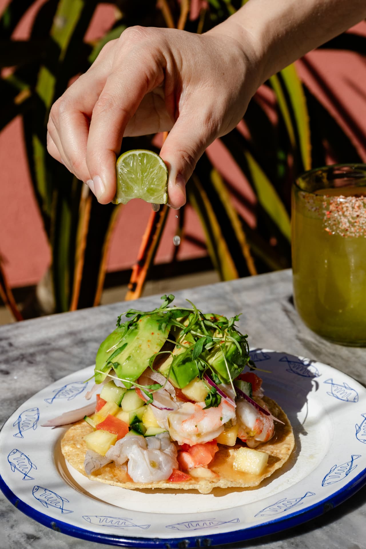Lime squeezed over a shrimp ceviche tostada at Mariscos Za Za Zá
